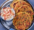 Indian breakfast koki flatbread with raita yogurt dip Royalty Free Stock Photo