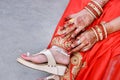 Indian bridal showing her footwear ,payal and mehandi