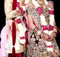 Indian bride and groom pose for beautiful portraits after their colorful jaimala ceremony