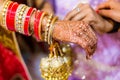 Indian bride with henna painted on arm and hands