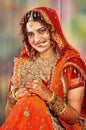 Indian bride in her wedding dress showing