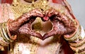 Indian bride making heart shape by her hands Royalty Free Stock Photo