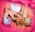 Indian Bride putting ring on indian Groom