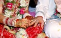 Indian Bride putting a wedding ring on groom`s finger Royalty Free Stock Photo