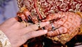 Indian Bride putting a wedding ring on groom`s finger Royalty Free Stock Photo