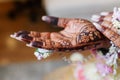 Indian bride\'s hand is decorated with henna designs and patterns in traditional Indian style