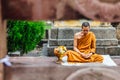 Indian Buddhist monk in meditation near The Bodhi Tree near Mahabodhi Temple while raining at Bodh Gaya, Bihar, India