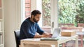 Indian business man remote working on laptop computer sitting at home office. Royalty Free Stock Photo