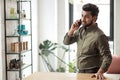 Indian business man talking on phone in modern office Royalty Free Stock Photo