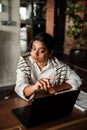 Indian business woman pointing at laptop and discussing something while sitting in office Royalty Free Stock Photo