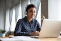 Indian businesswoman wearing headphones lead negotiations through videoconference call