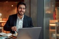 Indian businessman eating lunch during break after work in cafe and looking at the window Royalty Free Stock Photo