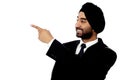 Indian businessman pointing away Royalty Free Stock Photo