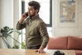 Indian business man talking on phone in modern office Royalty Free Stock Photo