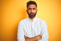 Indian businessman wearing white elegant shirt standing over isolated yellow background skeptic and nervous, disapproving Royalty Free Stock Photo