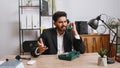 Indian businessman working, having talk with client on retro old-fashioned wired telephone at office Royalty Free Stock Photo