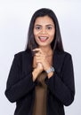 Indian businesswoman with hands clasped acting surprised