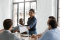 Indian businesswoman leader giving team members documents for review Royalty Free Stock Photo