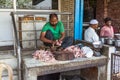 Indian butcher prepares chicken
