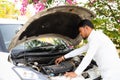 indian cab driver checking or repairing car engine after traveling - concept of self car maintainence, transportation Royalty Free Stock Photo