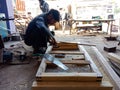 an indian carpenter chopping wood logs at workshop in India dec 2019