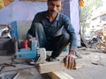 an indian carpenter finishing wood logs at workshop in india dec 2019