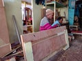 an indian carpenter making wooden furniture at workshop in india January 2020