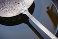 Close-up of Indian cast iron cooking ware frying pan with oil