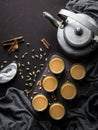 Indian chai in glass cups with metal kettle and other masalas to make the tea.