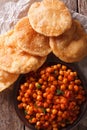 Indian Chana masala and puri bread close-up. Vertical top view