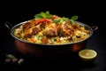 Indian chicken biryani served in a copper bowl on black background, Indian chicken biryani with rice and vegetables on a black Royalty Free Stock Photo