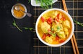 Indian chicken curry with basmati rice in blue bowl. Traditional Indian dish.