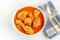 Indian Chicken Curry in a Bowl with Fork and Spoon on White Background Royalty Free Stock Photo