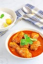 Indian Chicken Curry in a Bowl with Fork and Spoon on White Background Royalty Free Stock Photo