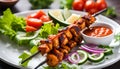 Indian Chicken Tikka Kebob on skewers in a white plate. Served with salad. Close Up Photo. Royalty Free Stock Photo