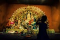 A indian child taking picture of Durga idol during Durga puja celebration in Kolkata