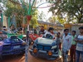 indian children seating at car swing on fair in India January 2020