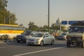 Indian city traffic on the background of the white dome of the temple