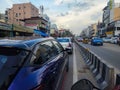 Indian cityscape view, traffic jam on two lane road. residential building and commercial shop beside the roads