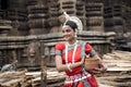 Indian classical dance.Beautiful Odissi dancer holding Abadha Mahaprasad at Ananta Basudev temple