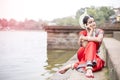 Indian classical odissi dancer seating near Bindu Sagar, bhubaneswar, Odisha, India