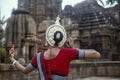 Indian Classical odissi dancer wears traditional costume and posing in front of Mukteshvara Temple,Bhubaneswar, Odisha, India