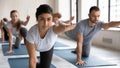 Indian coach and group of people doing Bird Dog Pose