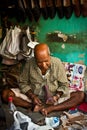 Indian cobbler at work, Delhi, India