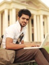 Indian College student working on laptop. Royalty Free Stock Photo