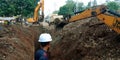 Indian construction engineer working on road with hydraulic machine in india oct 2019