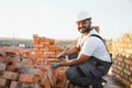 Indian Construction worker man in work clothes and a construction helmet. Portrait of positive male builder in hardhat Royalty Free Stock Photo