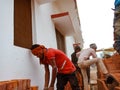 Indian construction workers unloading bricks from tractor at site in India dec 2019