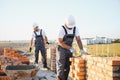 Indian construction workers work on the construction of a brick house. Construction of a brick wall Royalty Free Stock Photo