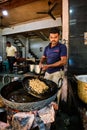 Indian cook makes fresh street food Murukku. Pushkar, Rajasthan, India